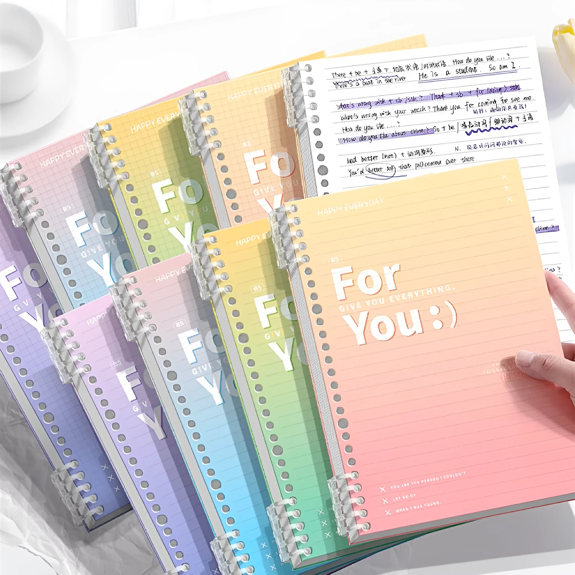 Gradient coloured removable coil notebook in blue, green, pink, or purple, showing A4 and B5 size options.