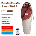 Grey mummy-style goose down sleeping bag for adults, packed in its included storage bag.