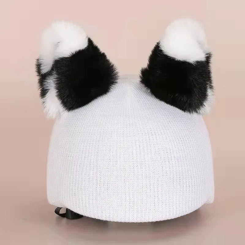 Plush cartoon-themed cover set on a medium motorcycle helmet with soft ear decorations.