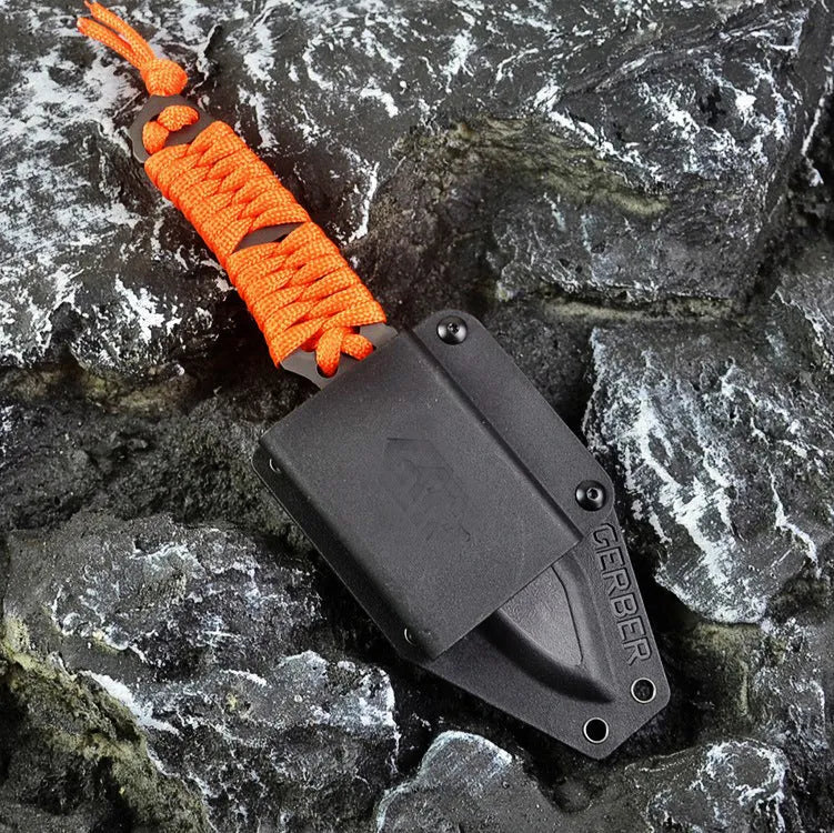 Camping knife with straight blade and rope bound handle showing ABS sheath