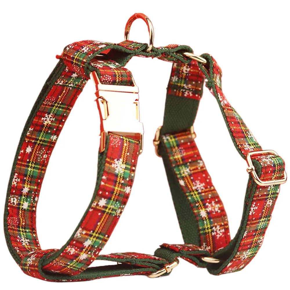 Green fabric Christmas pet collar and leash set with snowflake pattern, including a vest and decorative bow.