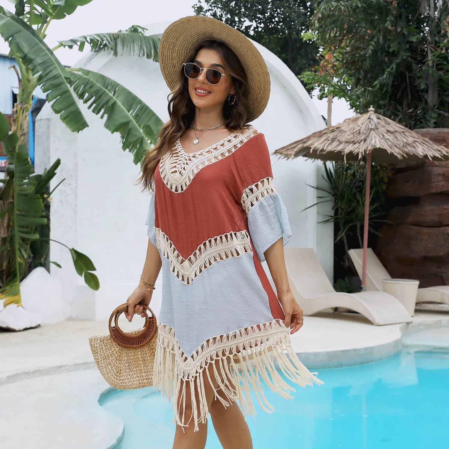 Orange hand-crochet beach overskirt with floral pattern and tassels, part of a matching set