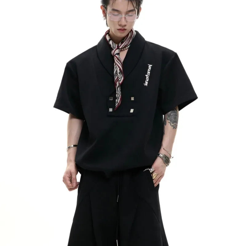 Men's dark grey V-neck cotton sports jacket with padded shoulders and metal details, paired with matching shorts.