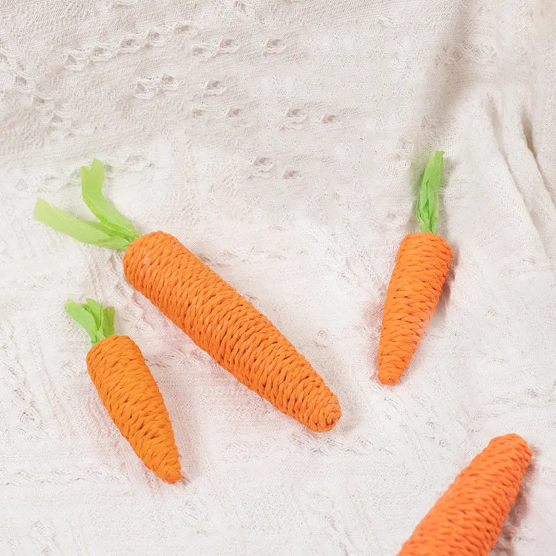 Assortment of interactive cat toys including carrot-shaped paper toys, ringing stones, and cat sticks in two sizes