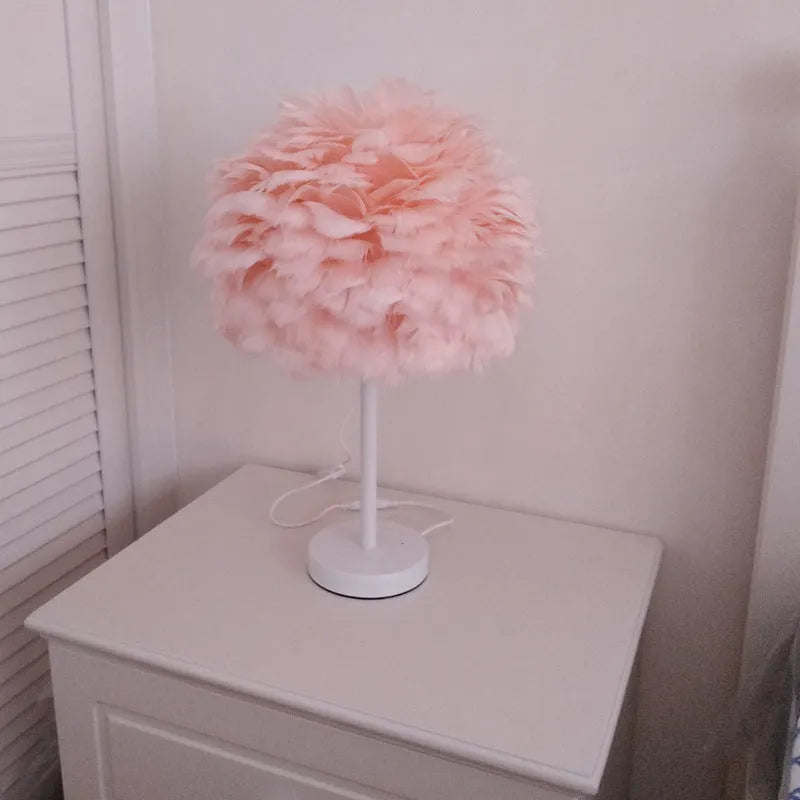 White handmade feather table lamp with metal base on a wooden desk, remote control visible, 30cm diameter