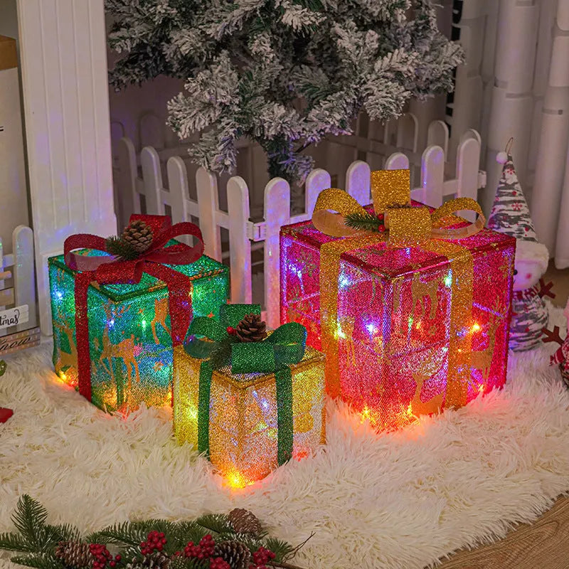 Set of three pre-lit Christmas gift box decorations with bows for outdoor holiday displays