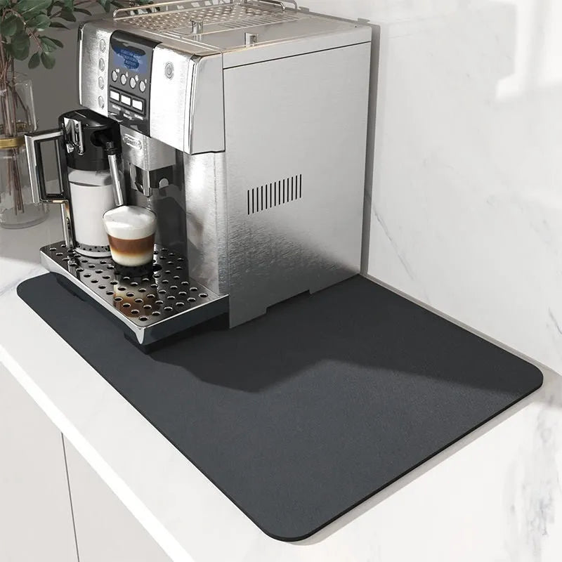 Black square super absorbent PU leather kitchen drain pad drying mat with anti-slip backing on a countertop.