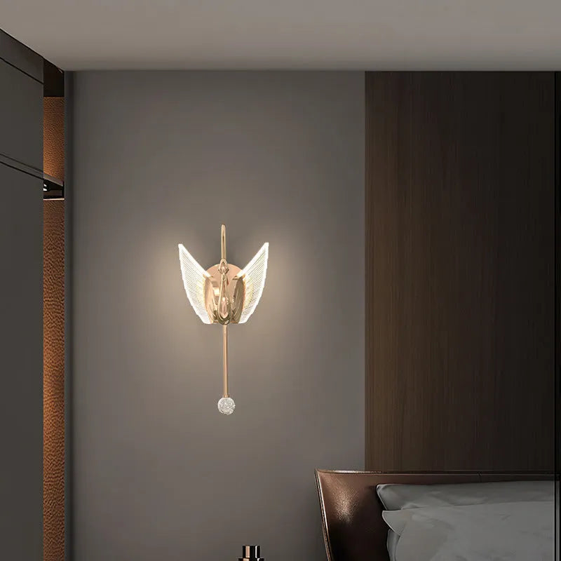 Minimalist swan-shaped wall lamp with gold finish and white acrylic shade.