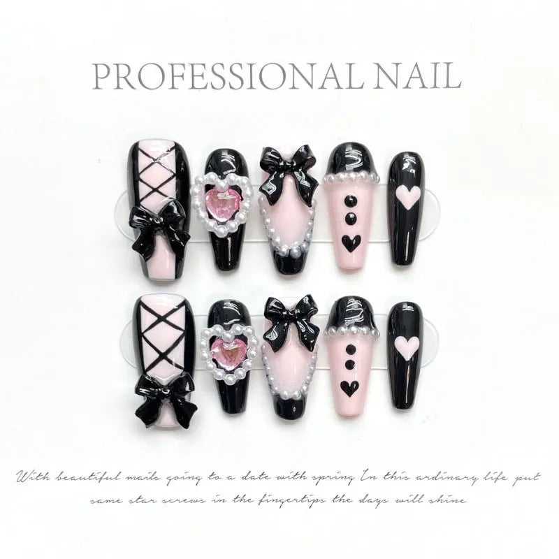 Handmade black peach heart nail art with detachable bow patterns on plastic armour suit