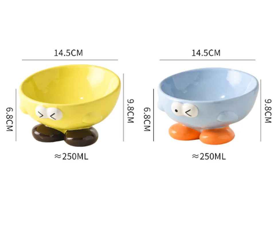 Blue and yellow ceramic slanted pet food bowls with animal face expressions for cervical spine support.