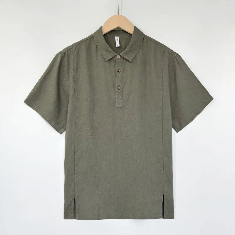 A man wearing a loose-fitting linen summer top with thin lapels and short sleeves.