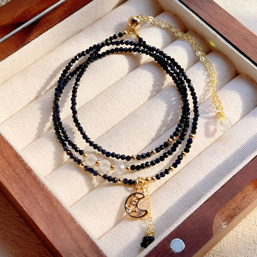 Women's multi-layer bracelet made of blue sand stone with three rings and gold-coloured accents.