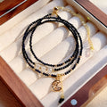 Women's multi-layer bracelet made of blue sand stone with three rings and gold-coloured accents.