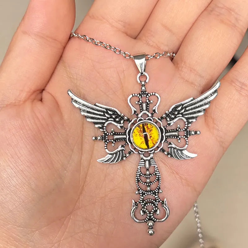 Close-up of a colourful alloy necklace featuring a geometric pendant with devil wings and a cross design.