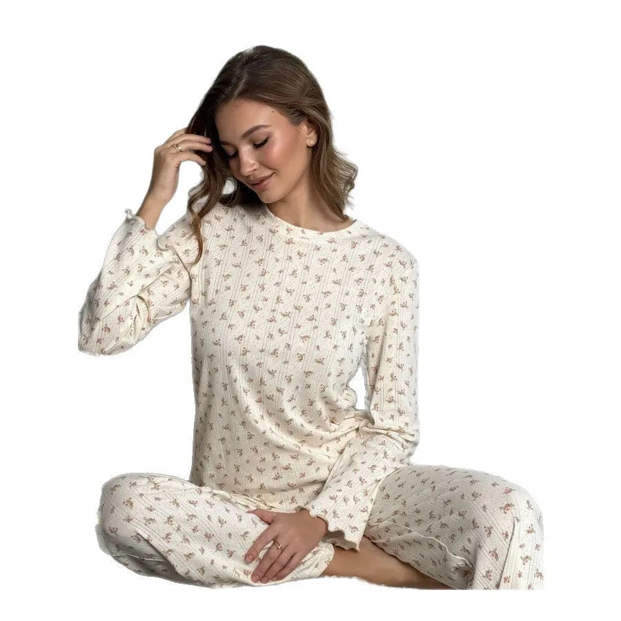 White floral print women's suit with bell sleeve top and wide leg trousers on hanger