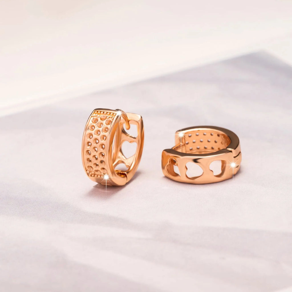 A pair of circular rose gold women's earrings with a three-heart hollowed-out design.