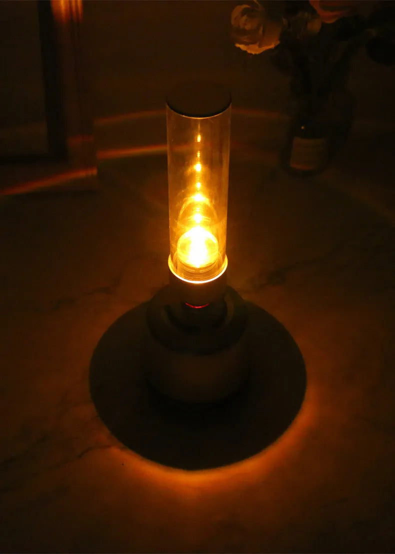 White silver cylindrical Bluetooth speaker night light with candlelight LED glow.