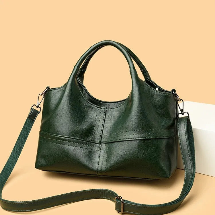 Soft leather crossbody handbag in black, bucket shape with single shoulder strap, lightweight design for women