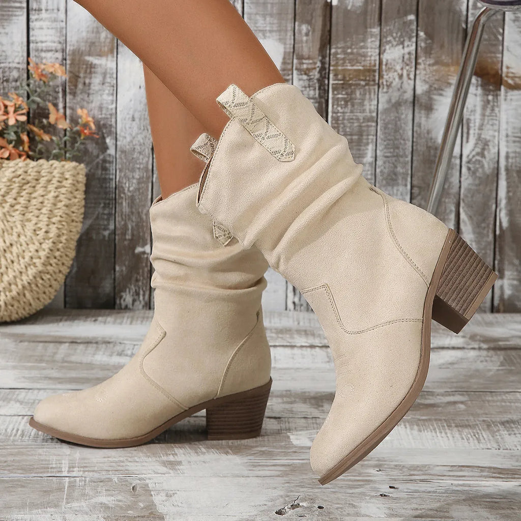 Women's suede mid-calf boots in lotus root colour with leather stitching and a mid heel.