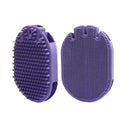 Purple dual-sided pet shampoo and massage brush with soft TPR bristles and ergonomic handle.