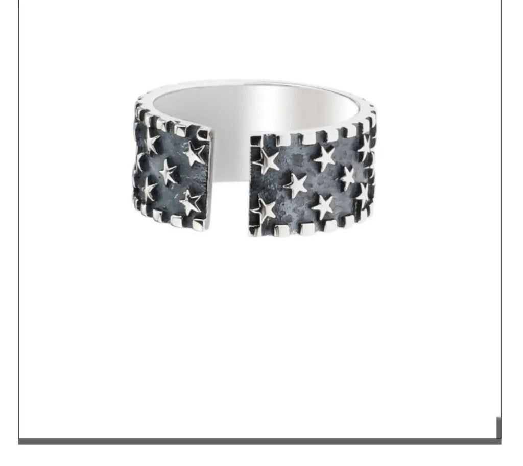 Sterling silver ring with geometric multi star pattern and adjustable opening.