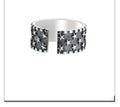 Sterling silver ring with geometric multi star pattern and adjustable opening.