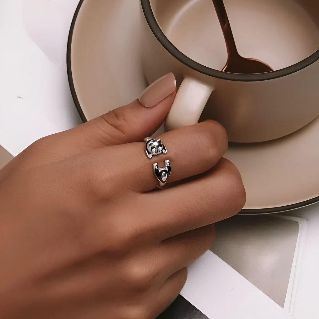 Adjustable sterling silver ring with a white gold plated panda design.