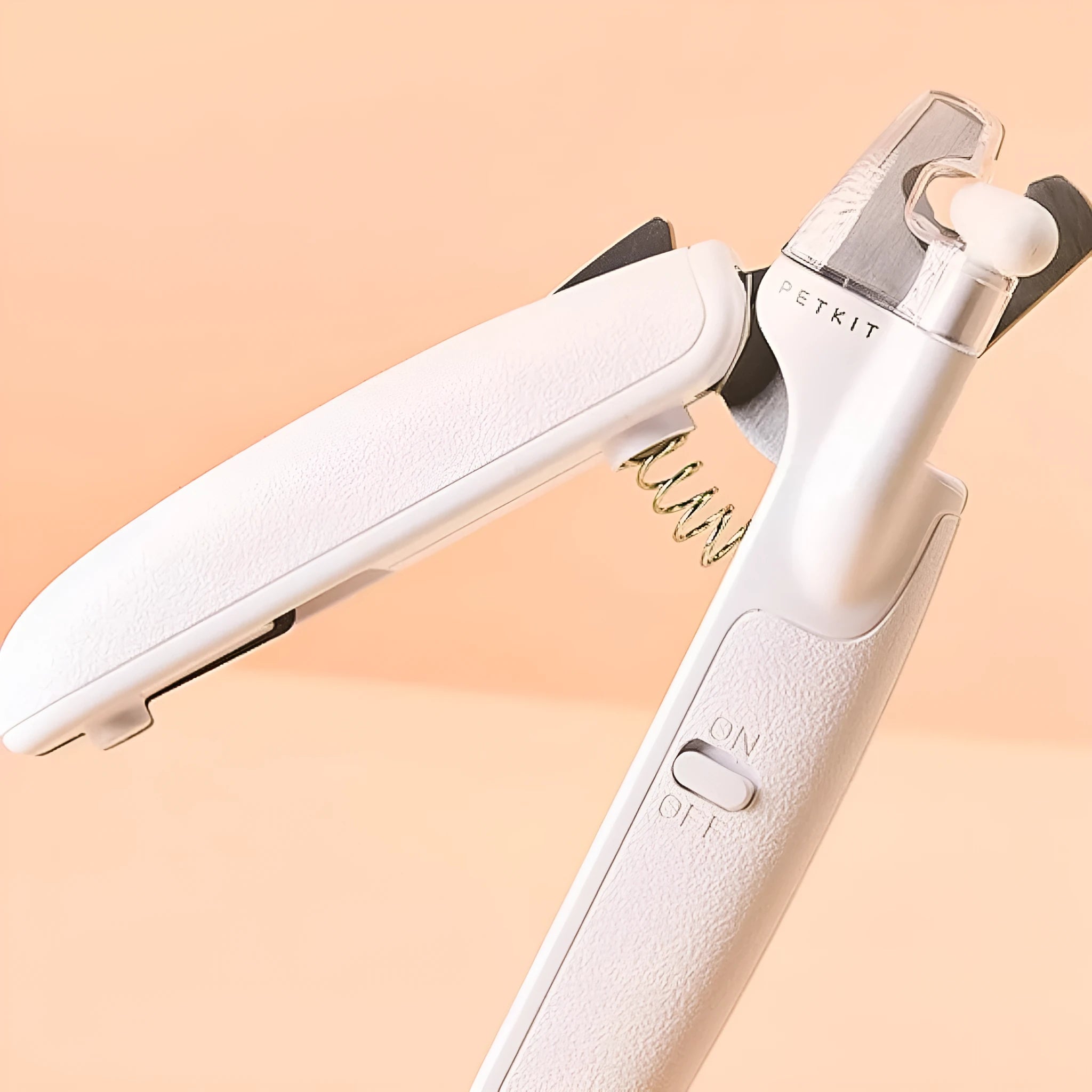 White LED pet nail clippers for cats and dogs with open transparent safety guard and nail file.