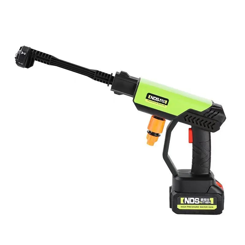 Green wireless high-pressure water gun with metal head and multiple nozzle attachments on a table