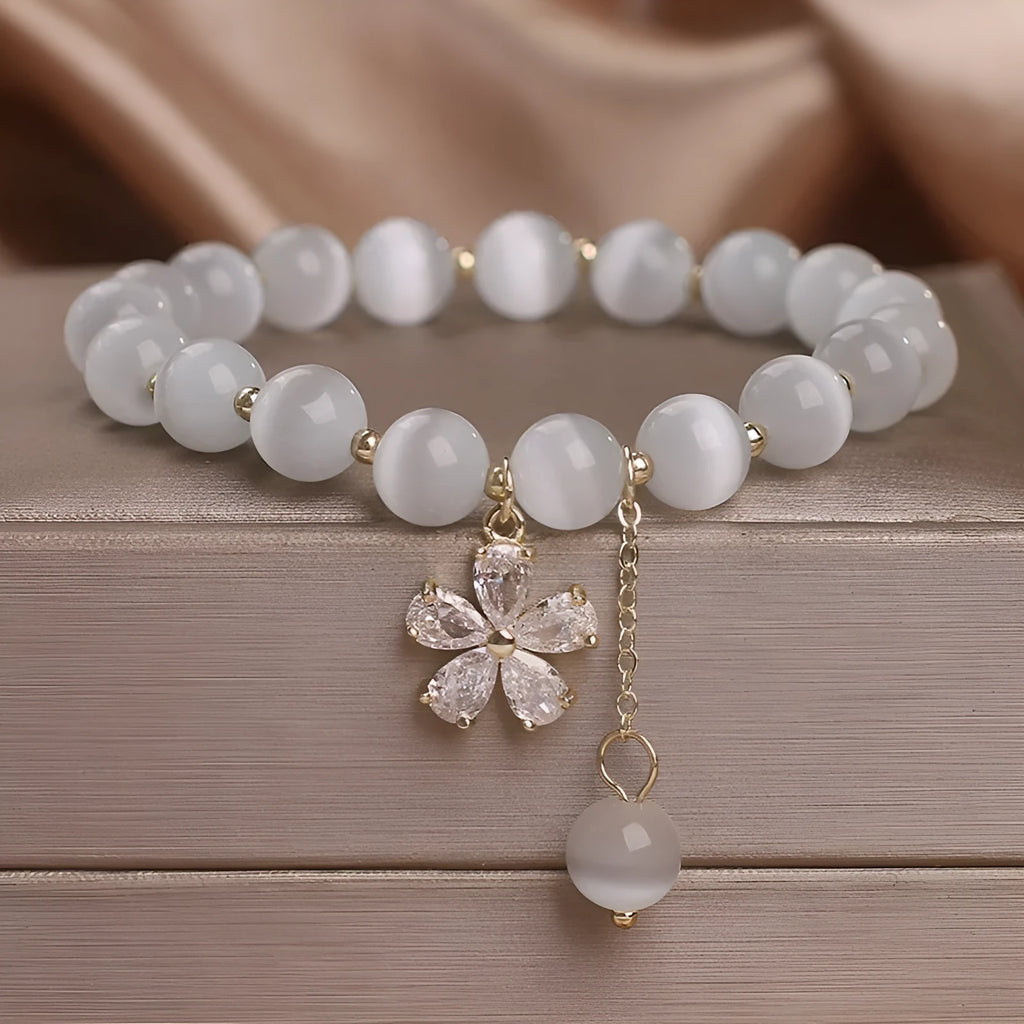Women's white cat's eye crystal bracelet with floral tassel and morganite safety buckle pendant