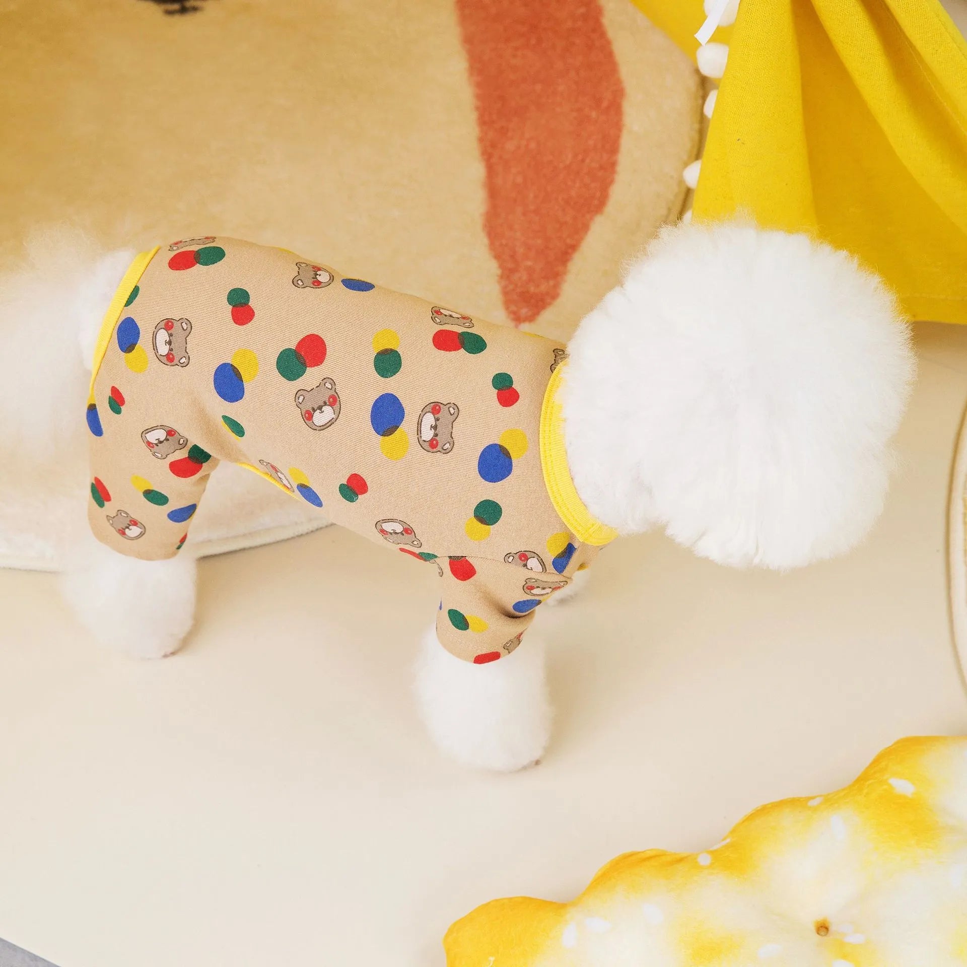 Beige dog jumper with colourful ball bear print, shown on a dog, made from cotton and spandex blend.