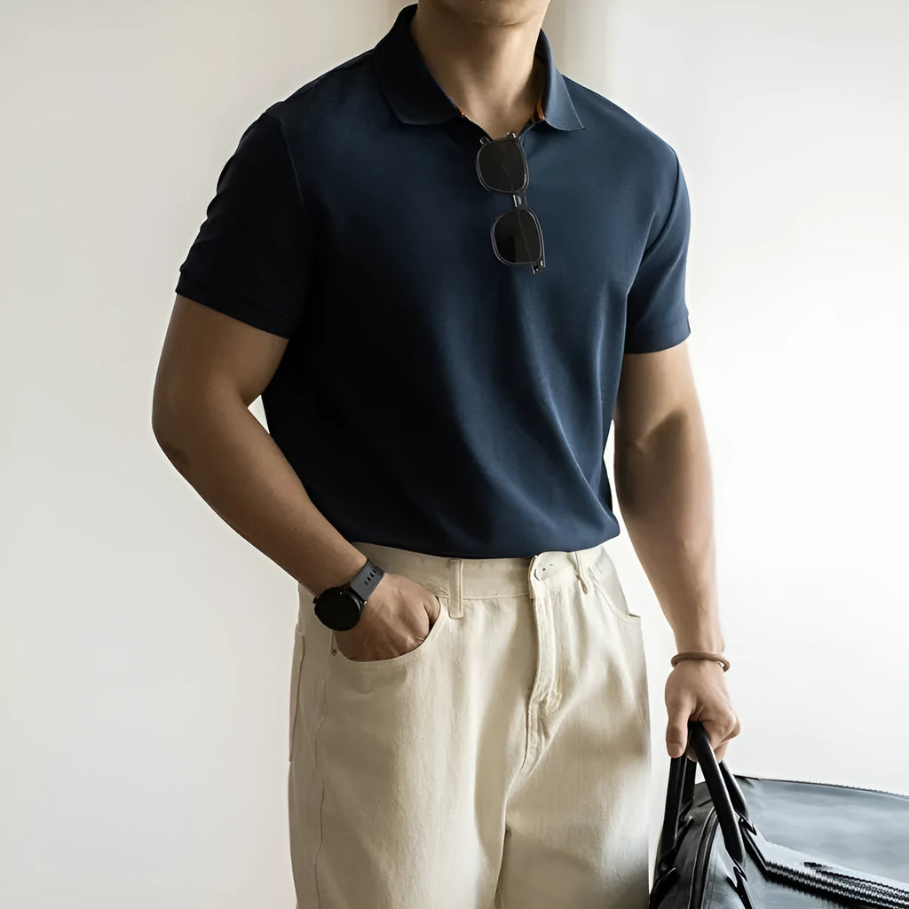 American-style short-sleeved polo shirt in blue on hanger showing regular fit and cotton blend fabric.
