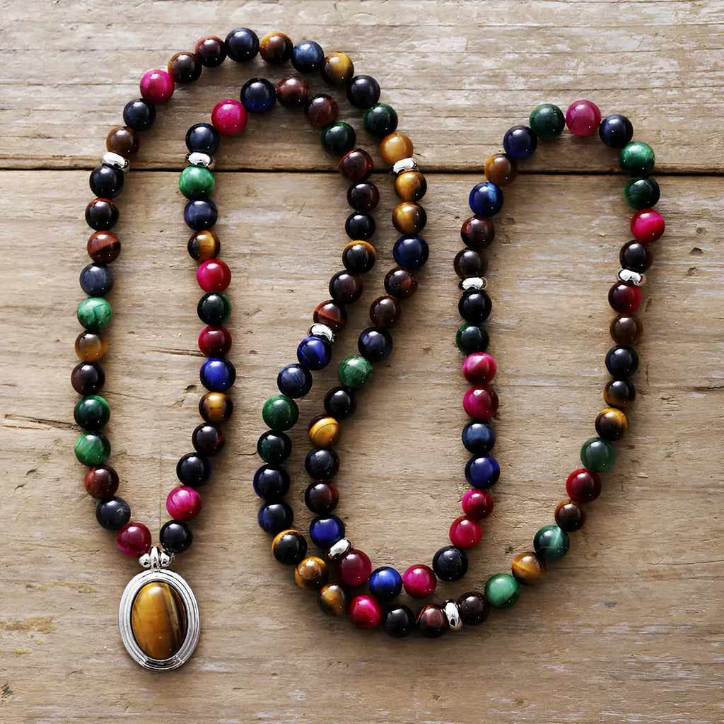 Close-up of a tiger-eye stone bead necklace with 108 gem-inlaid pendants showing heart, crown, and infinite symbols.