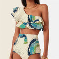 White women's one shoulder swimsuit with a layered lotus leaf skirt and a thigh high split.