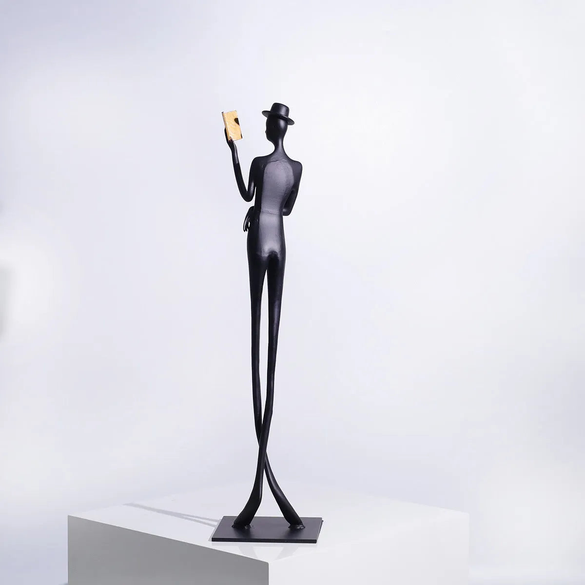 Black cast aluminium desktop sculpture of a reading woman, modern simplicity style