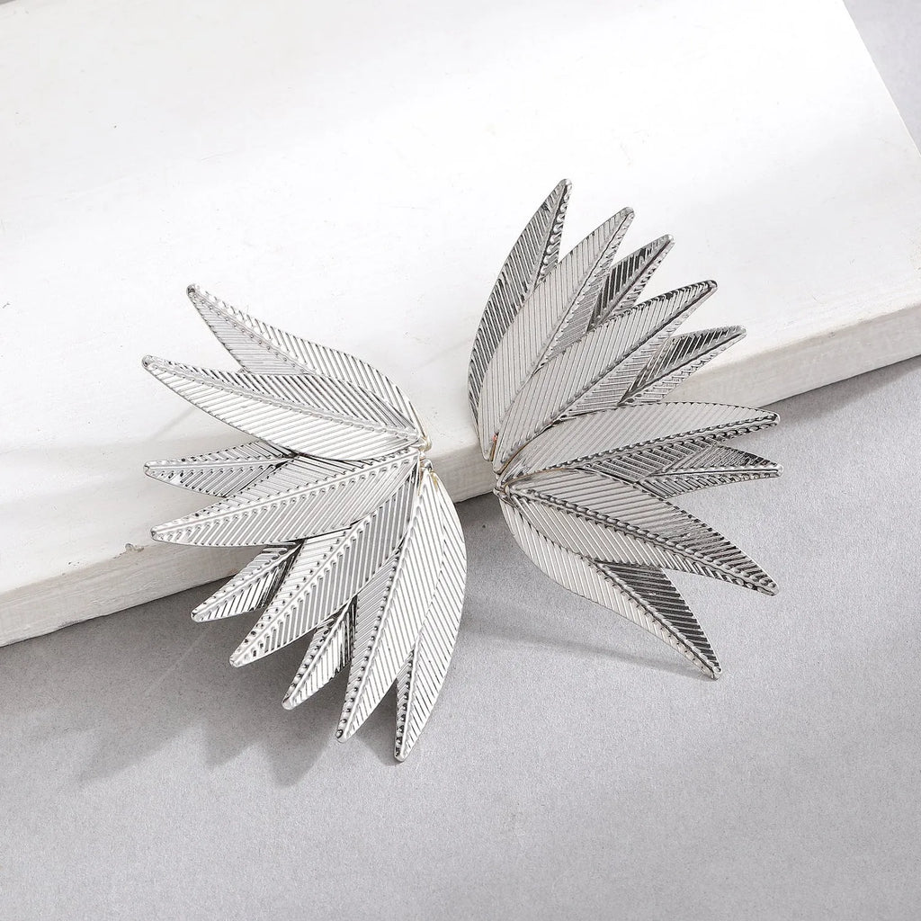 Gold and white leaf-shaped alloy patch earrings showing botanical design