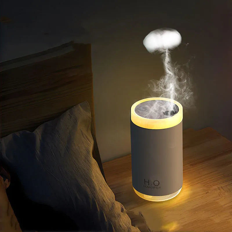 USB jellyfish humidifier producing smoke-ring mist with warm night light in blue, pink, or white colours