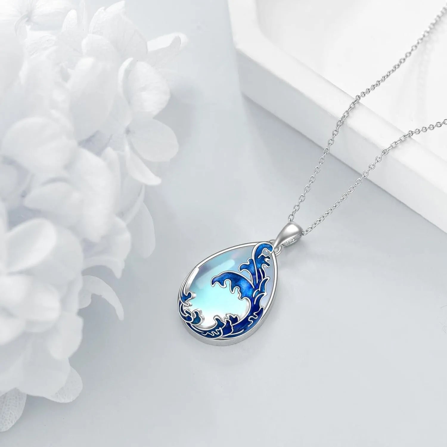 Blue alloy pendant necklace with heart design elements on a metal chain