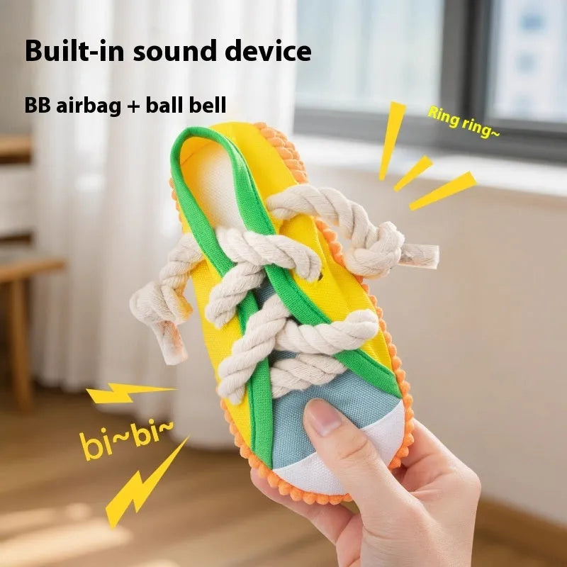Yellow plastic dog slipper toy with a squeaker for chewing.