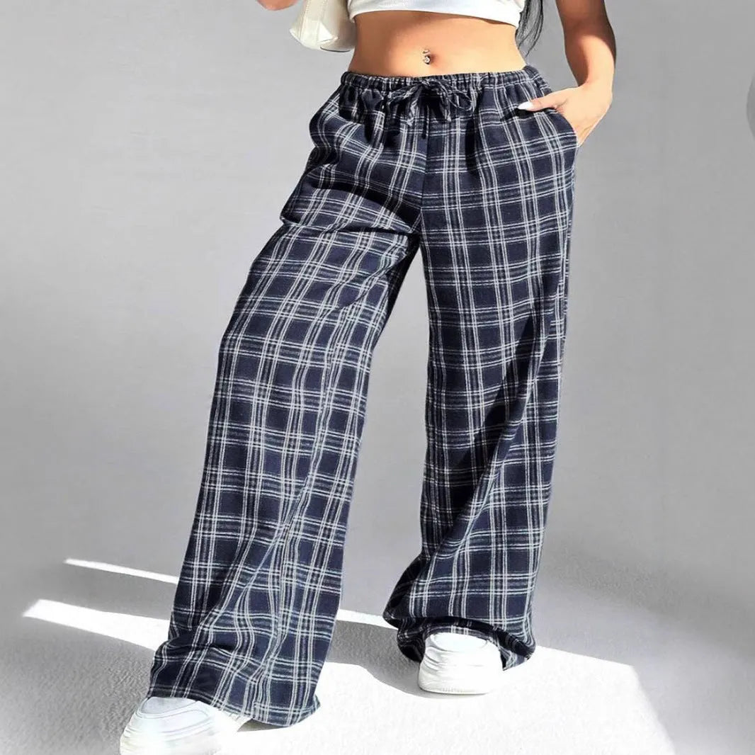 Women's red plaid trousers with drawstring waist and side pockets on mannequin display