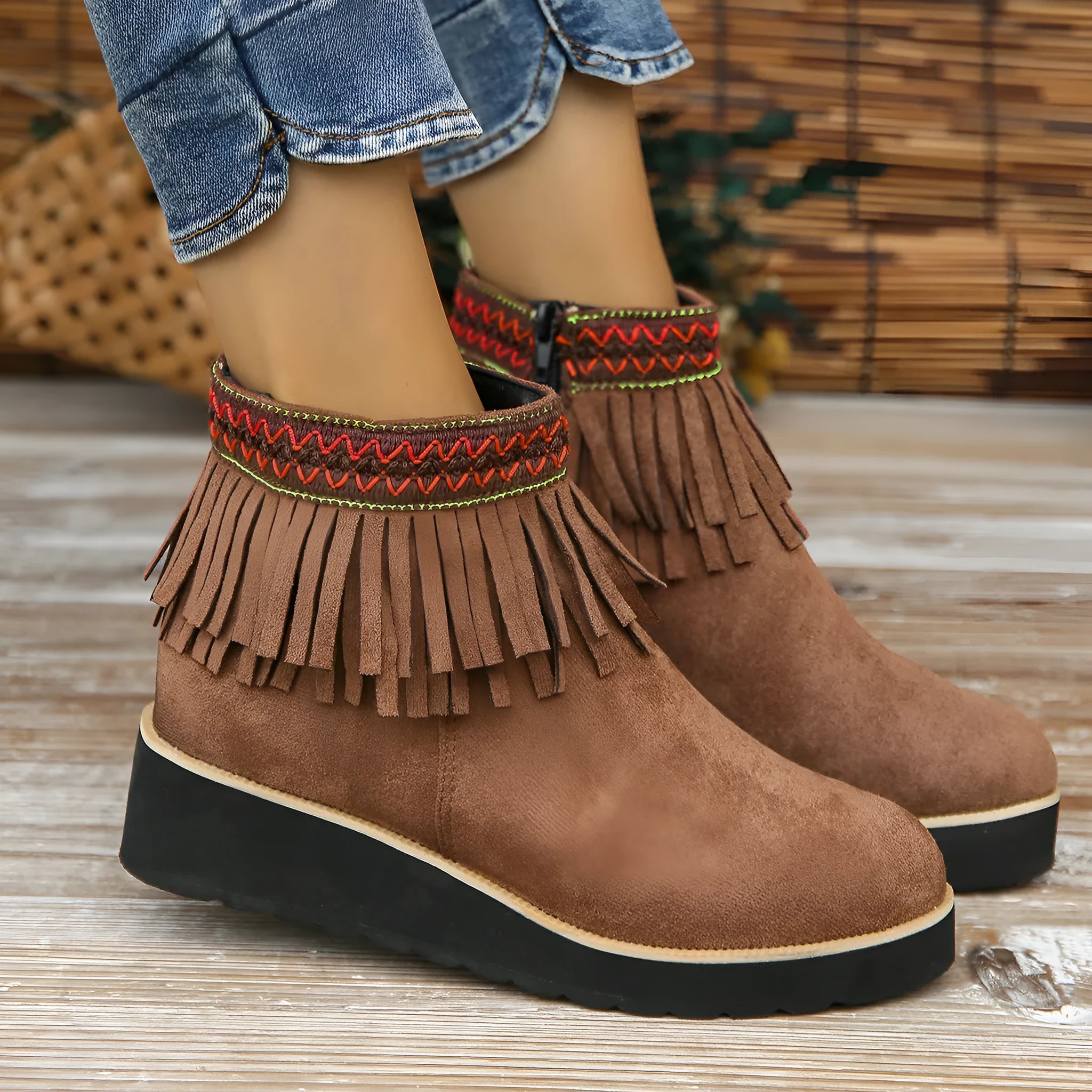 Women's dark brown suede wedge ankle boot with side zipper, tassel, and thick waterproof platform sole.