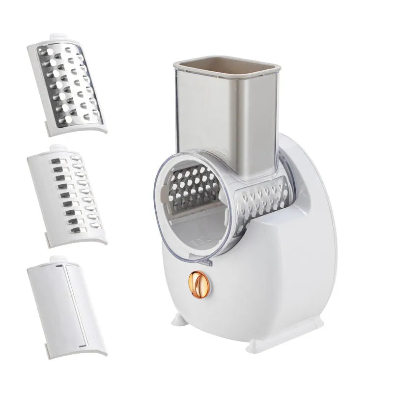 White electric vegetable slicer with suction base and multiple blade options on kitchen counter