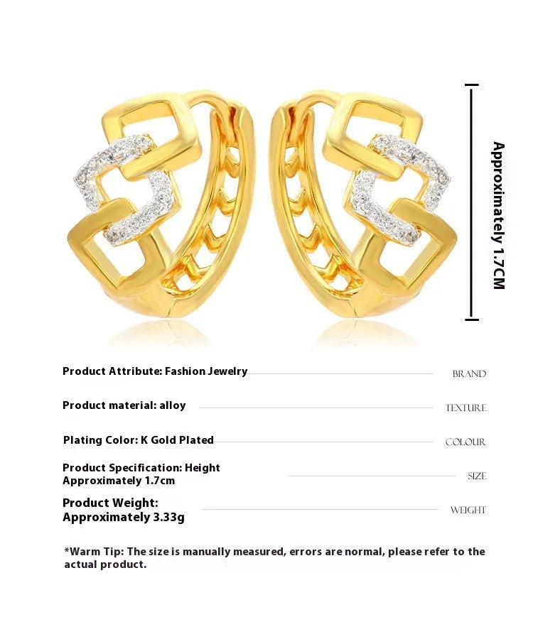 A pair of gold-coloured geometric drop earrings with a hollow out design on a plain background.
