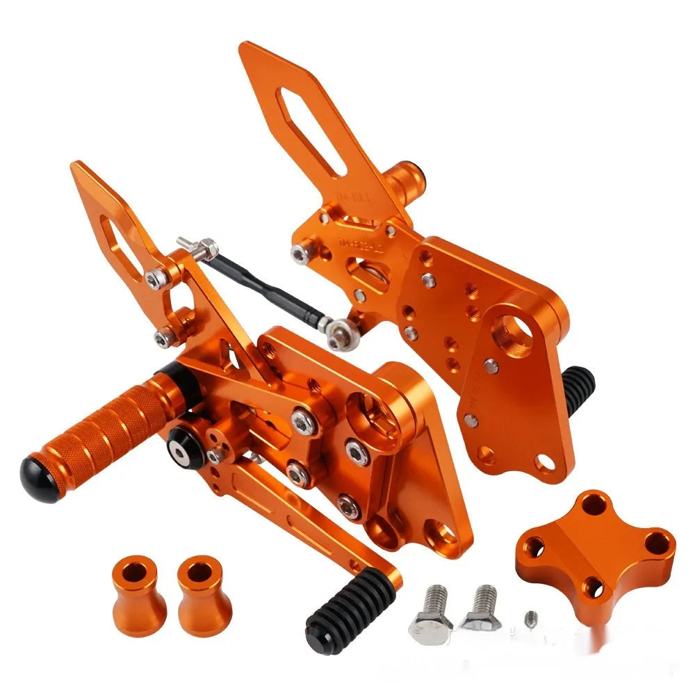 Black and orange KTM Duke motorcycle raised footrest bracket assembly