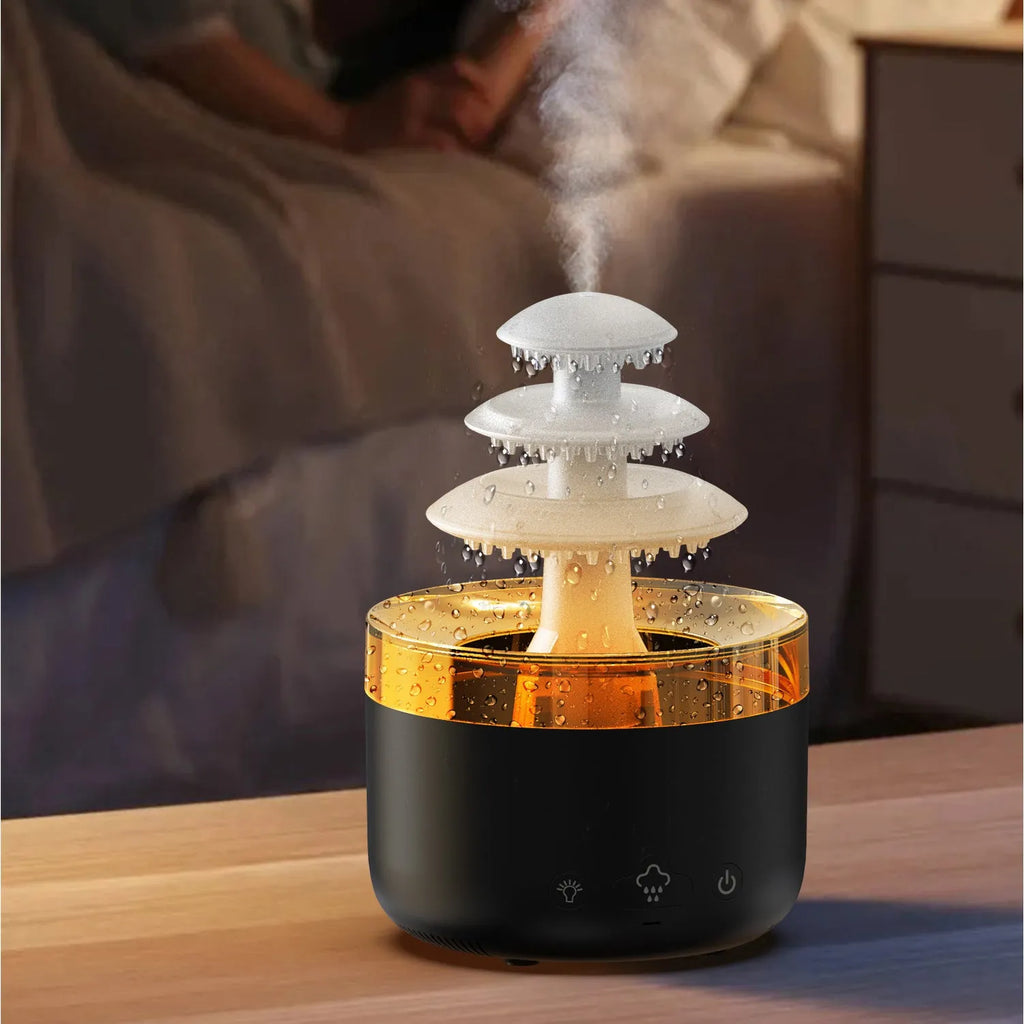 White cloud-shaped ultrasonic humidifier and essential oil diffuser with colourful LED light on base.