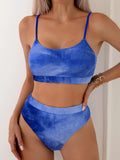 Women's blue and orange tie-dye pleated split bikini with gradient pattern on polyester fabric