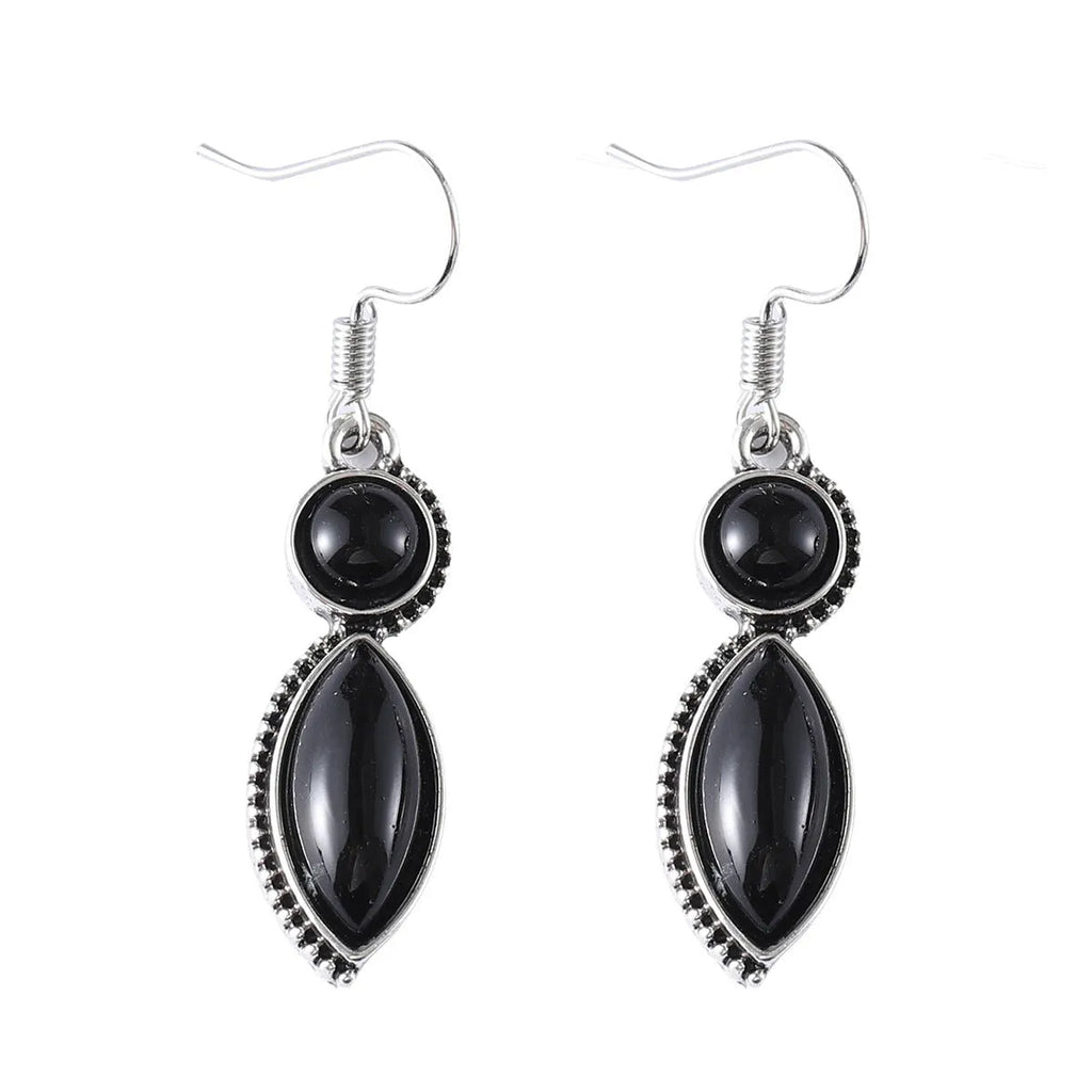 A pair of vintage-style geometric drop earrings in black and purple with a round element, bohemian jewellery.