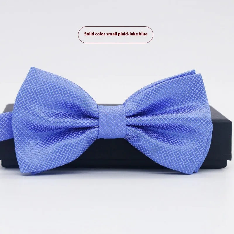 Flat-head polyester bow tie in a solid colour, shown with dimensions 12 cm by 6 cm.