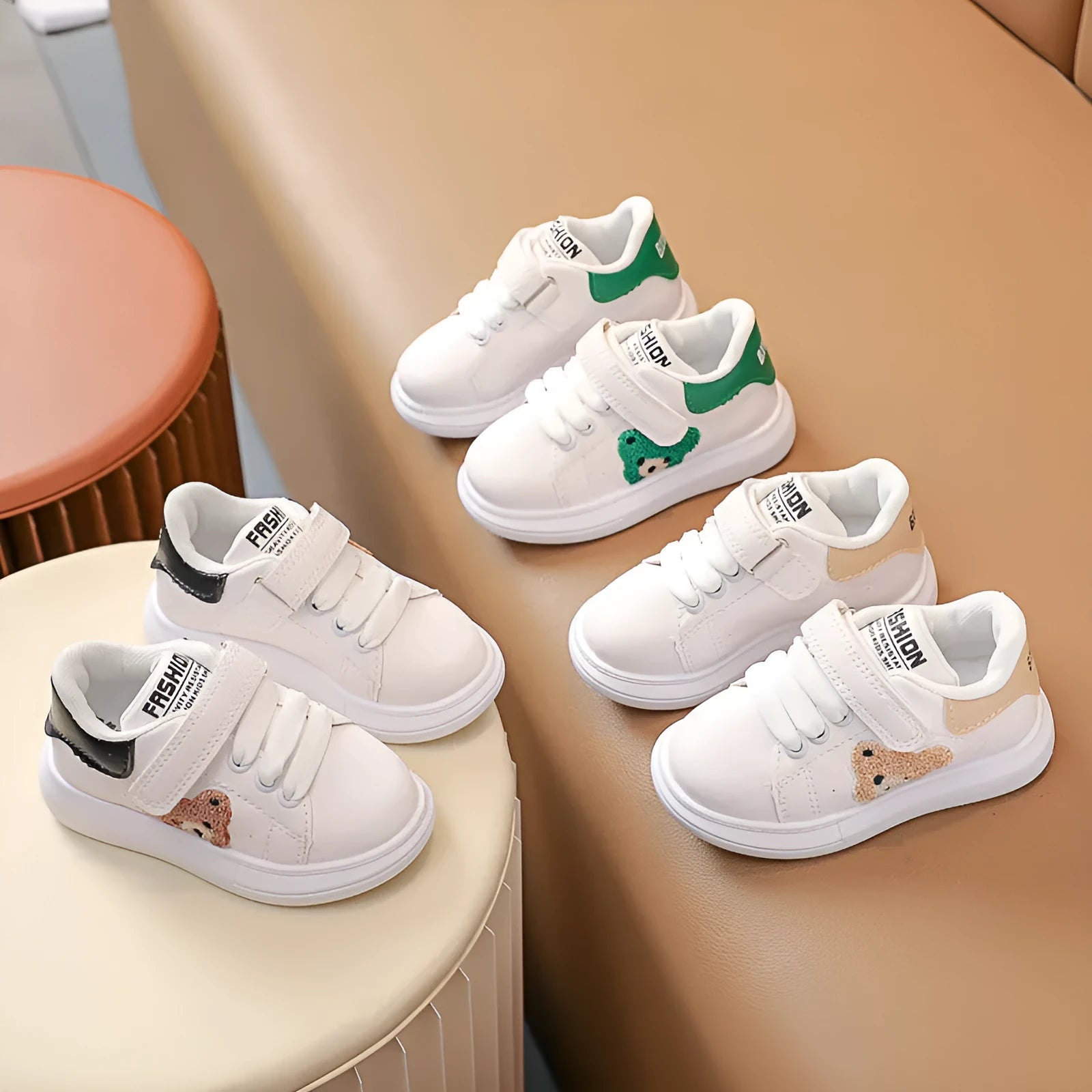Children's black casual sports shoes with a cartoon bear design on the side, featuring an artificial leather upper and rubber sole.