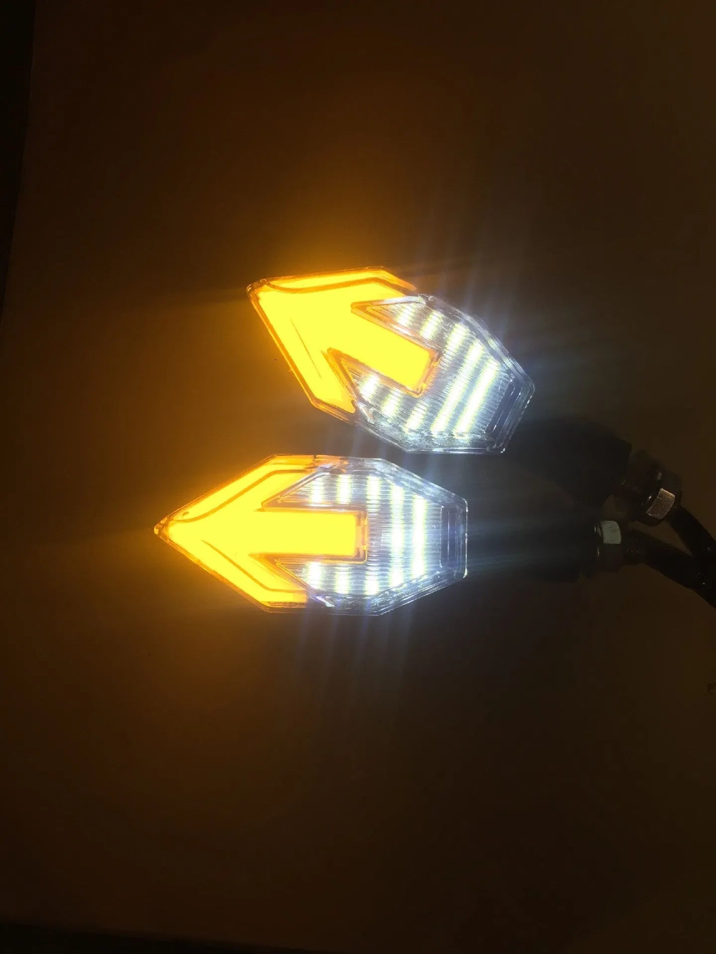 Arrow-shaped LED motorcycle direction indicator light with 12V yellow and coloured accent options.